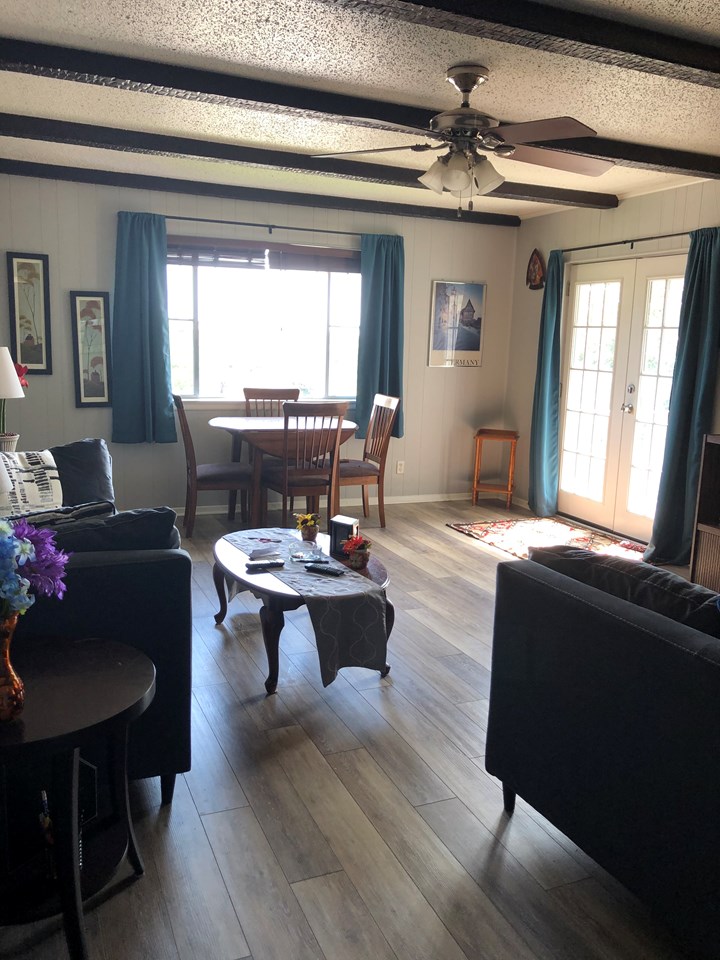 living room with door leading out to the deck