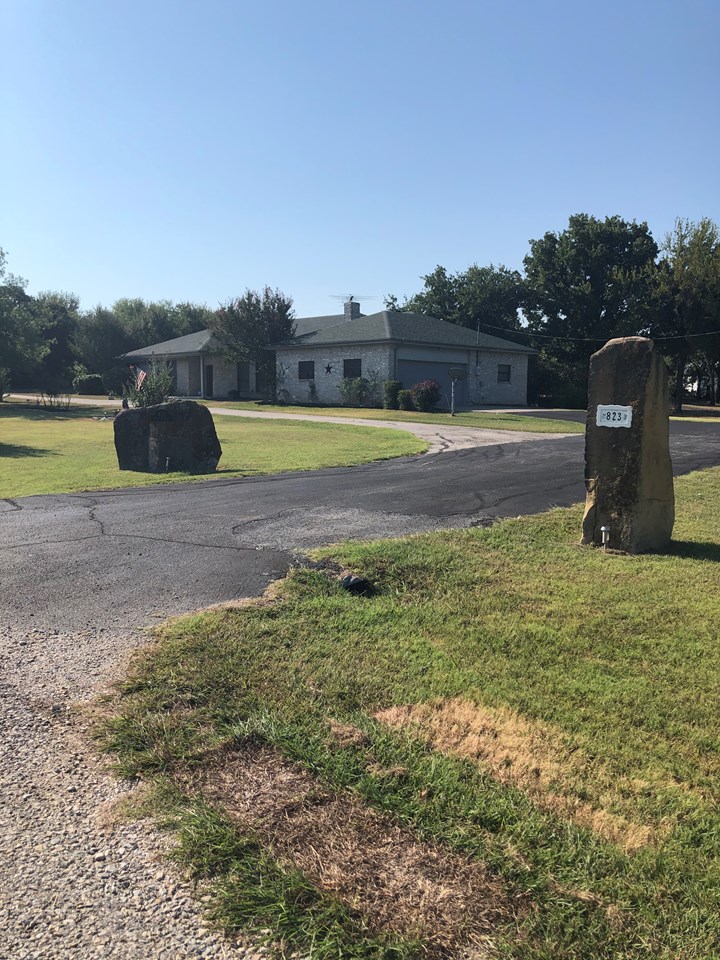 a great place to call home convenient circle drive in front and side entry garage.  asphalt drive leads on to the golf cart garage and storage shed near the back of the property.