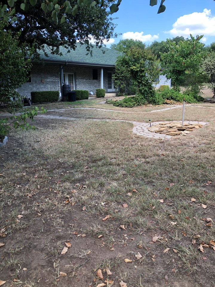 back of the house the back yard has lots of landscaping, patio area, and built in barbeque on the back porch