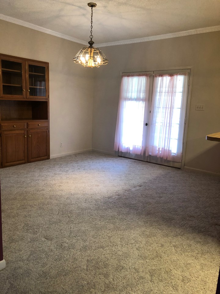 dining room the dining room features a built in china cabinet and french doors going to the back yard