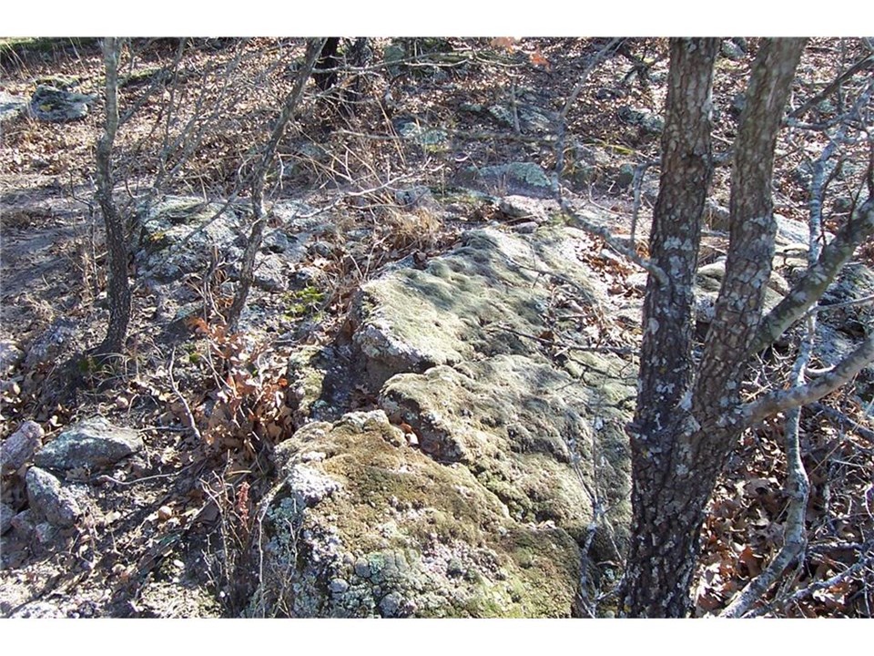 moss rocks  large rocks are along the hill side and creek